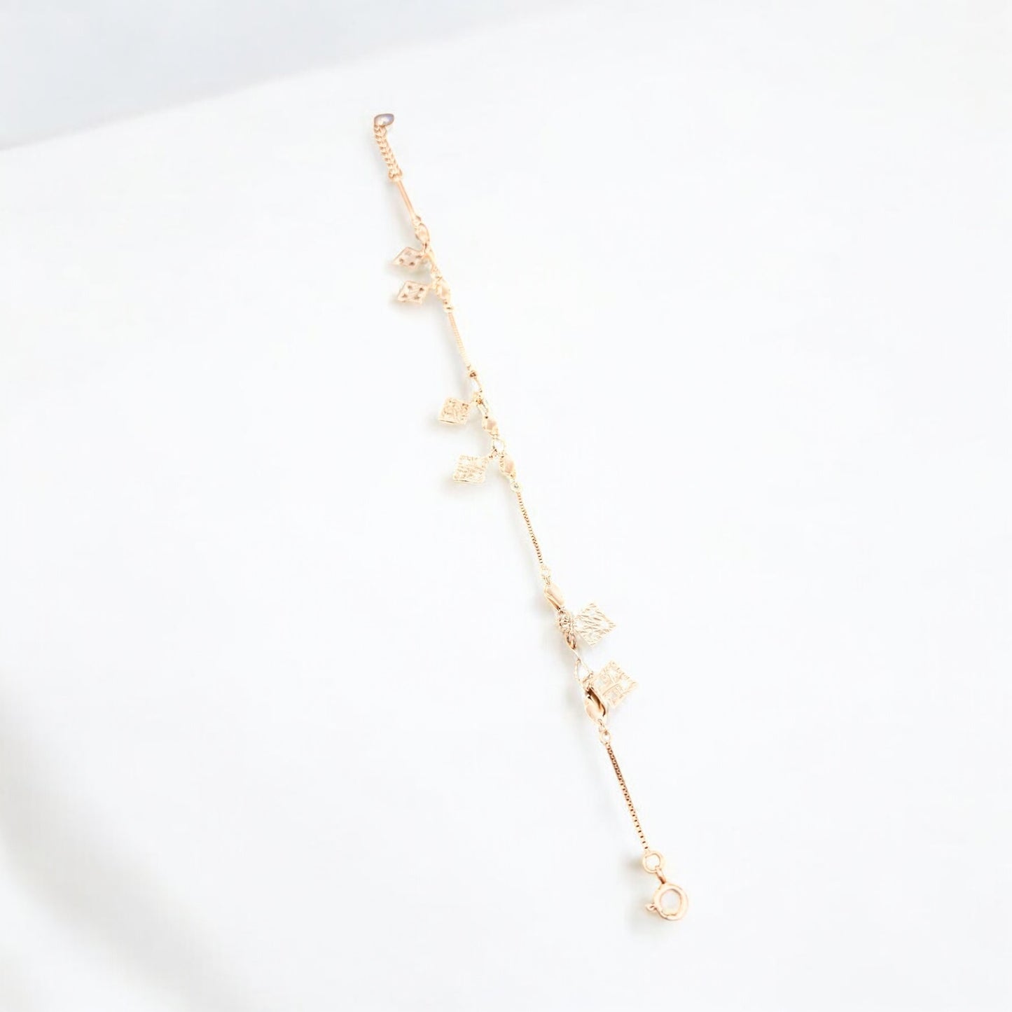 Rose gold bracelet with twisted charms