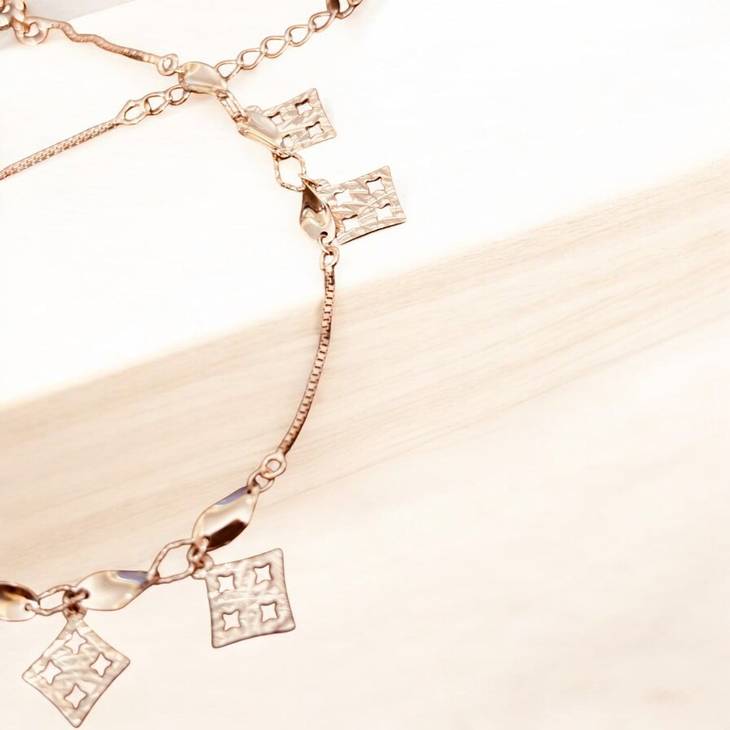 Rose gold bracelet with twisted charms