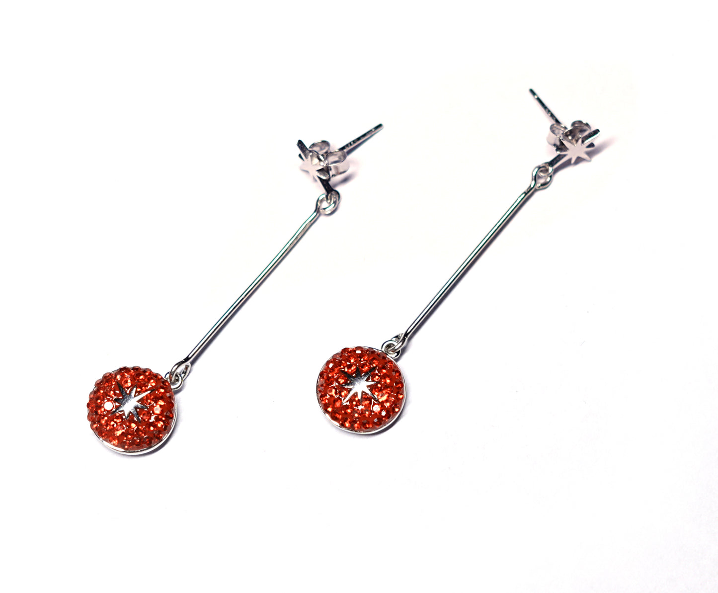 Pair of orange gemstone drop earrings on a white background
