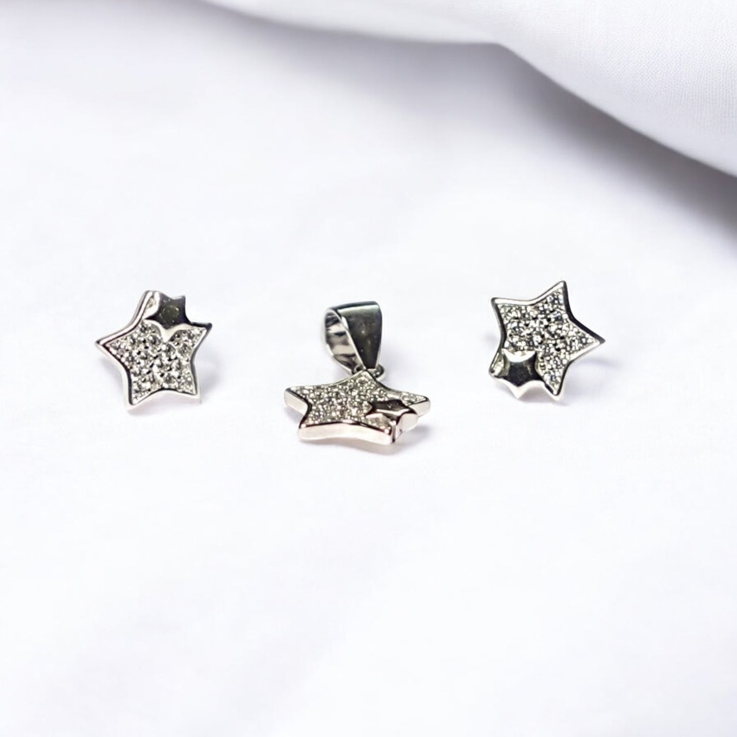 Star-shaped silver jewelry set on a white background