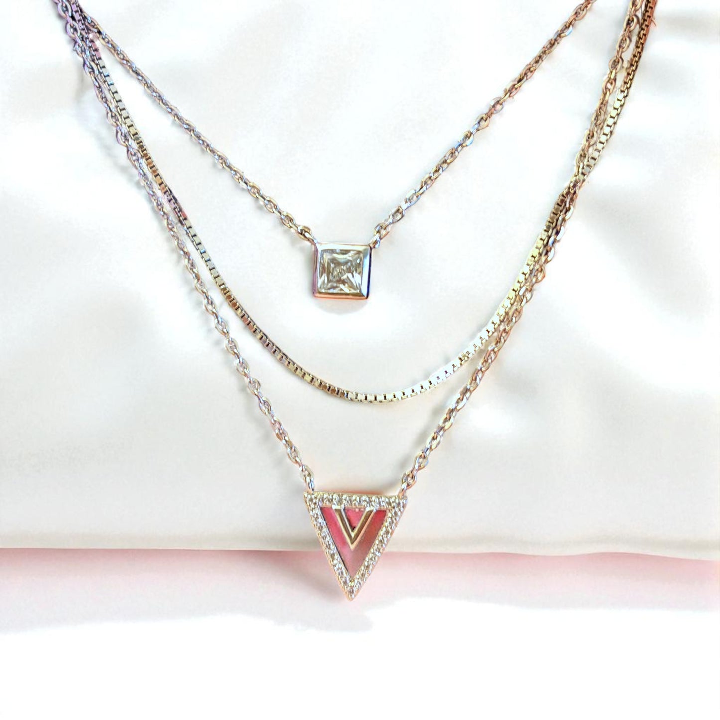 Two necklaces with different pendants on a white background