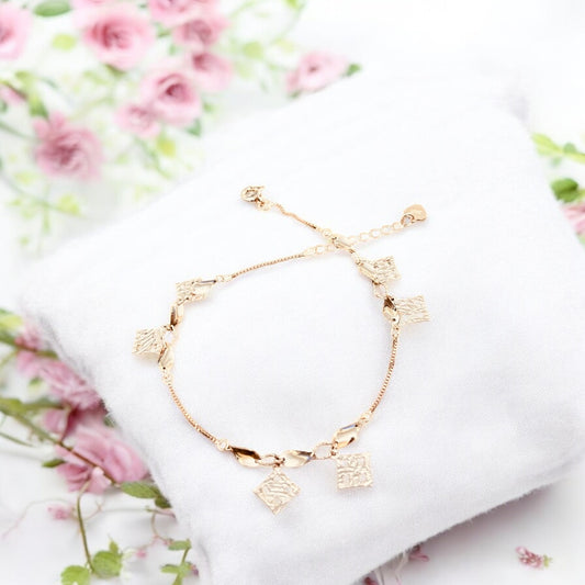 Rose gold bracelet with twisted charms