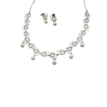 Necklace and earrings set with geometric design and pearl accents on a white background