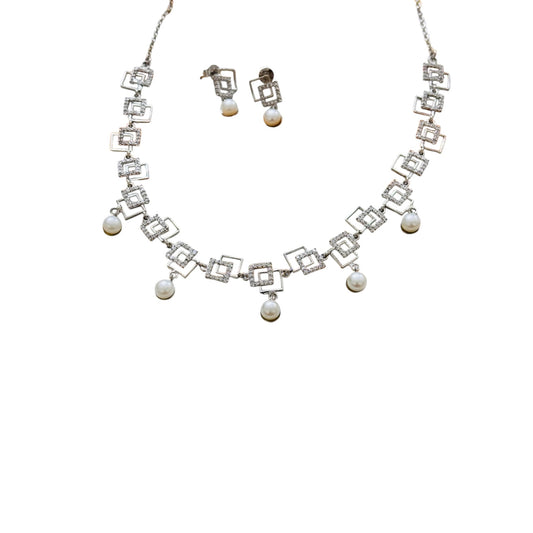 Necklace and earrings set with geometric design and pearl accents on a white background