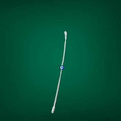 Silver bracelet with a blue bead on a green background