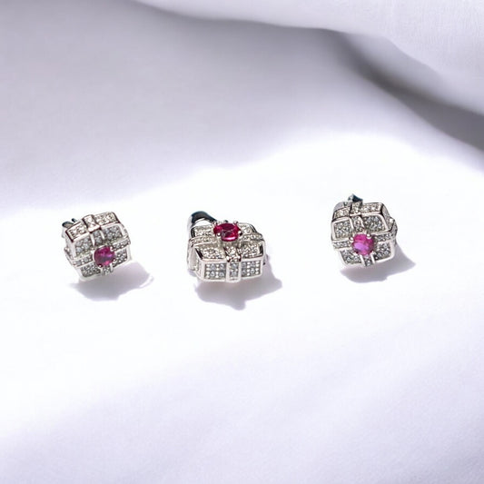 Pair of silver earrings with pink gemstones on a white background