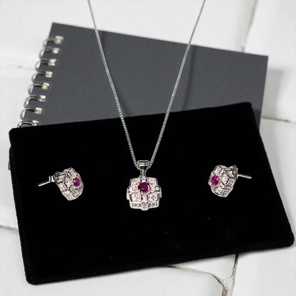 Jewelry set with pendant and earrings on a black display stand