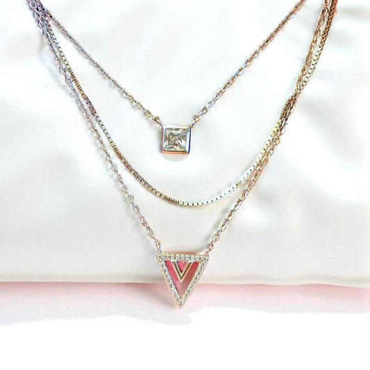 Two necklaces with different pendants on a white background